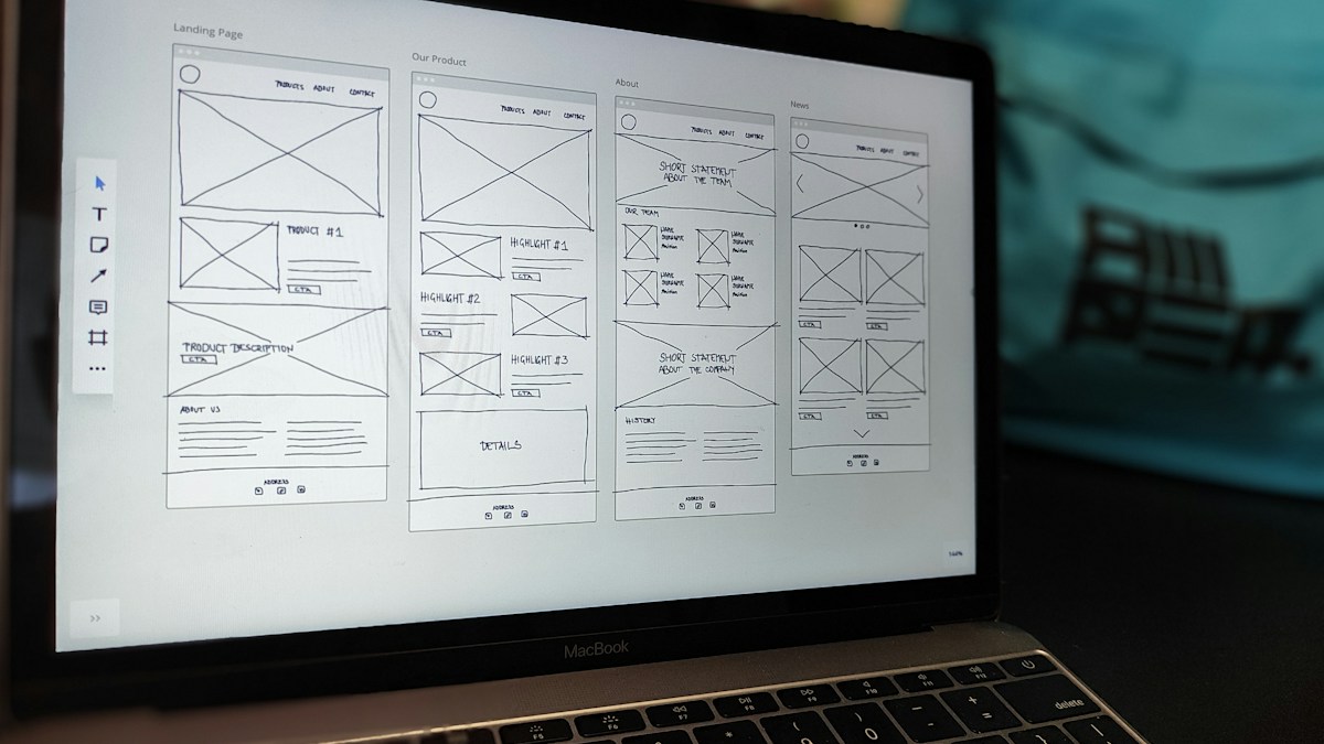 Website page layouts displayed on a laptop